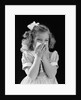 1940s little blond girl ribbon in hair holding tissue to nose sneezing by Anonymous