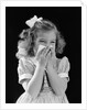1940s little blond girl ribbon in hair holding tissue to nose sneezing by Anonymous