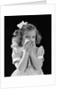 1940s little blond girl ribbon in hair holding tissue to nose sneezing by Anonymous