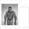 1960s man walking on crutches looking at camera by Anonymous
