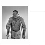 1960s man walking on crutches looking at camera by Anonymous