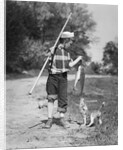 1950s boy plaid shirt sailor hat fishing pole dog pulling on tail of caught fish by Anonymous