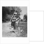 1950s boy plaid shirt sailor hat fishing pole dog pulling on tail of caught fish by Anonymous