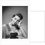 1950s housewife woman in print apron hand up to temple headache pain sad depressed facial expression worried serious looking at camera by Anonymous