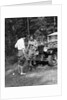 1920s 1930s couple man woman in fishing gear holding poles standing in front of packard touring automobile by Anonymous