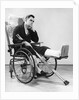 1940s man in wheelchair with cast on left leg holding crutches by Anonymous