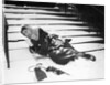 1950s woman lying on snow covered steps fall accident slip expression of pain by Anonymous