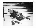 1950s woman lying on snow covered steps fall accident slip expression of pain by Anonymous