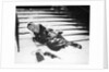 1950s woman lying on snow covered steps fall accident slip expression of pain by Anonymous