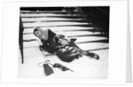 1950s woman lying on snow covered steps fall accident slip expression of pain by Anonymous