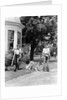 1940s boy with fishing gear collie dog second boy mowing grass with push mower by Anonymous