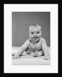 1950s portrait of baby sitting and sticking tongue out looking at camera by Anonymous