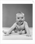 1950s portrait of baby sitting and sticking tongue out looking at camera by Anonymous