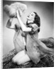 1950s young woman wearing sexy lingerie kneeling on leopard skin holding fluffy dog by Anonymous