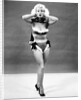 1950s young woman standing inside wearing fur trimmed bikini and gloves by Anonymous
