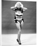 1950s young woman standing inside wearing fur trimmed bikini and gloves by Anonymous