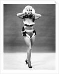 1950s young woman standing inside wearing fur trimmed bikini and gloves by Anonymous