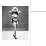 1950s young woman standing inside wearing fur trimmed bikini and gloves by Anonymous