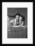 1950s mother & daughter admiring baby in bassinet by Anonymous