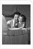 1950s mother & daughter admiring baby in bassinet by Anonymous