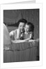 1950s mother & daughter admiring baby in bassinet by Anonymous