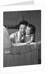 1950s mother & daughter admiring baby in bassinet by Anonymous
