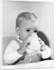 1950s boy toddler drinking glass milk looking at camera by Anonymous
