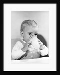 1950s boy toddler drinking glass milk looking at camera by Anonymous