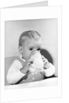1950s boy toddler drinking glass milk looking at camera by Anonymous