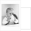1950s boy toddler drinking glass milk looking at camera by Anonymous