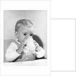 1950s boy toddler drinking glass milk looking at camera by Anonymous