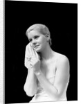 1930s blond woman washing face with washcloth towel by Anonymous