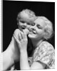 1930s blonde woman mother smiling holding baby to cheek by Anonymous