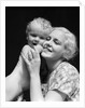 1930s blonde woman mother smiling holding baby to cheek by Anonymous