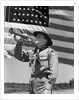 1940s boy scout playing bugle in front of 48 star american flag by Anonymous