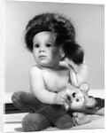 1960s baby wearing coonskin hat by Anonymous