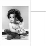 1960s baby wearing coonskin hat by Anonymous