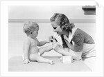 1930s mother touching baby toes fingers this little piggy nursery rhyme by Anonymous