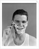1940s smiling man shaving wearing tee shirt by Anonymous