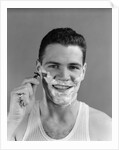 1940s smiling man shaving wearing tee shirt by Anonymous