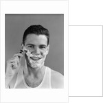 1940s smiling man shaving wearing tee shirt by Anonymous