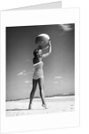 1960s woman in stripes swim suit bathing holding beach ball standing on tip toes by Anonymous