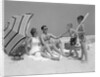 1960s at the beach two boys with baseball bat trying to pull up father seated next to mother so he will play with them by Anonymous