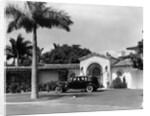 1930s car in circular driveway of tropical stucco spanish style home in sunset islands miami beach florida usa by Anonymous