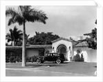 1930s car in circular driveway of tropical stucco spanish style home in sunset islands miami beach florida usa by Anonymous