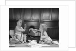 1960s 2 babies in diapers one on chair with telephone other on floor with adding machine pencil behind ear by Anonymous