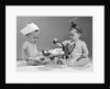1960s two babies playing doctor and nurse with doll studio by Anonymous