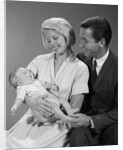 1960s happy mother and father smiling at their baby by Anonymous