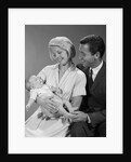 1960s happy mother and father smiling at their baby by Anonymous