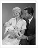 1960s happy mother and father smiling at their baby by Anonymous
